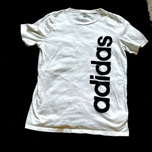 White T-shirt Adidas down the side brand is Adidas size is 1416 brand Adidas